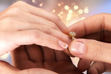 Close up Groom Putting the Wedding Ring on bride