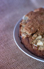 Homemade Healthy Vegan Oat apple pie pastry on burlap surface. Vertical view. Very Healthy Dessert concept.