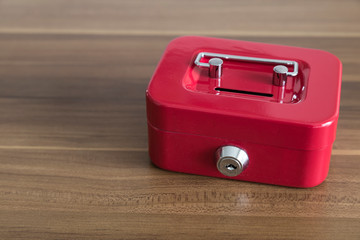 accumulate for poor people or investment .coins,hand and red moneybox on the white background for charity foundation concept.child throwing money into piggy bank.