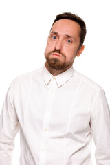 Handsome bearded man in a white shirt poses, isolated on a white background