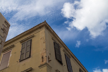Corner of a house and a cloudy sky