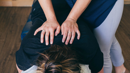 Chiropractor Adjusting with Hands on Back