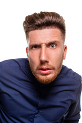 Fototapeta premium Attractive young man wearing blue shirt, isolated over a white background.