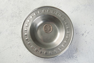 Vintage metal plate on concrete background.