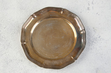 Vintage metal plate on concrete background.
