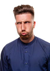 Obraz premium Attractive young man wearing blue shirt, isolated over a white background.