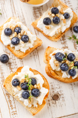 Toast with fresh berries blueberry Ricotta cheese, thyme, honey and hazelnuts, served