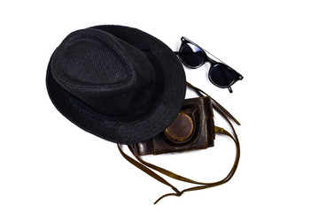 8.	 Black hat, dark sunglasses and leather antique camera case with belt on the isolated white...