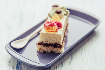 A slice of sponge cake on a rectangular plate.