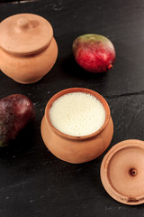 Fresh lassi in traditional indian clay pot.