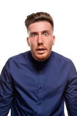 Attractive young man wearing blue shirt, isolated over a white background.