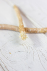 Miswak or siwak - arabian toothbrush for tooth cleaning on white.