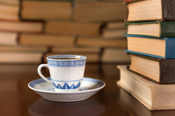 cup of coffee on the background of books