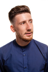 Fototapeta premium Attractive young man wearing blue shirt, isolated over a white background.