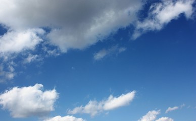 Blue blue sky with white fluffy clouds.