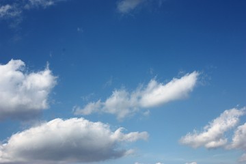 Blue blue sky with white fluffy clouds.