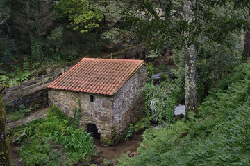 Obraz premium Traditional watermill in Galicia, Northern Spain. It was used to mill corn and cereal. It used to set up in torrents and rushing waters.