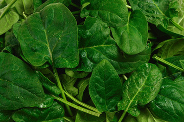 Fresh spinach leaves as background.