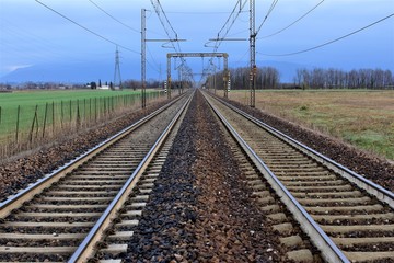 Fototapeta na wymiar railway in the field two strips of rail and wires above them