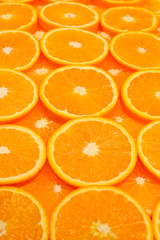 Slices of oranges as a background, top view.