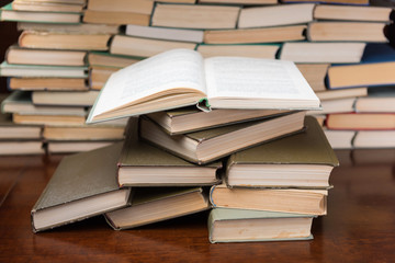stack of books on the wooden table