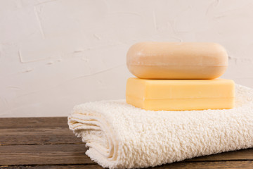 pieces of soap with towel on  wooden table