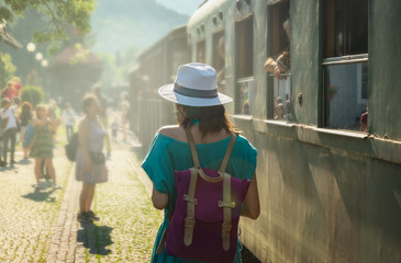 Traveler girl on train station in vacation.