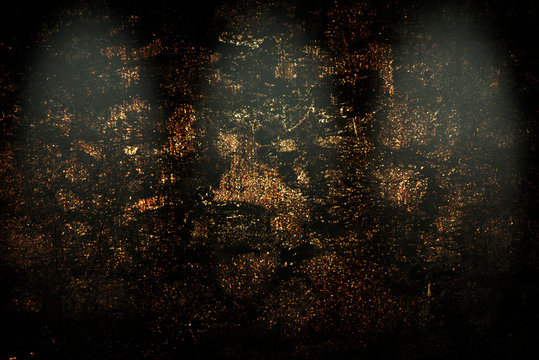 Old dark stone wall with gold inclusions with three stage lights spotlights.