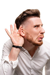 Obraz premium Studio photo of a good-looking man in a white shirt, isolated over a white background