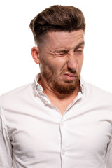 Obraz premium Studio photo of a good-looking man in a white shirt, isolated over a white background