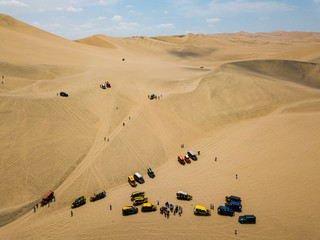 Fototapeta na wymiar sand dunes with dune buggies