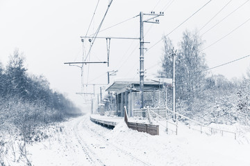 Winter landscape with empty railway station