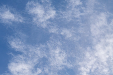Blue sky with clouds and sun reflection in water with place for your text. blue sky background with white clouds