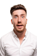 Obraz premium Studio photo of a good-looking man in a white shirt, isolated over a white background