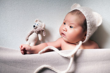 newborn baby asian boy sleeping at blue background