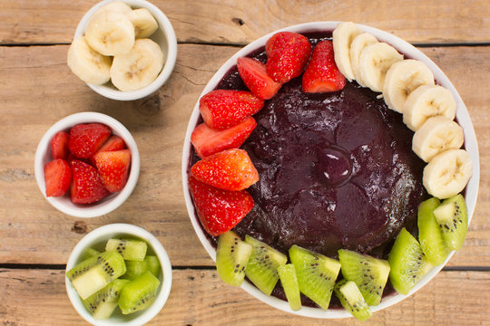 Brazilian acai and fruits in wood background seen from above