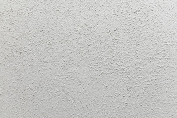 Surface of grey rugged wall in close-up as a texture or background