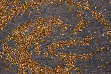 Lot of whole raw bulgur grains flatlay on grey stone