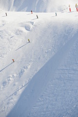 Skiing people in winter at black slope