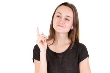 young woman pointing up at copyspace looks in camera
