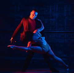 Passionate couple perform incendiary dance in night club