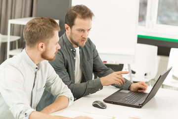 Two businessmen working at the office together