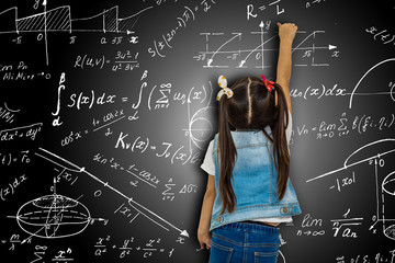 Girl against big blackboard with formulas, back view