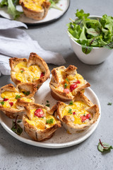 Egg muffins with peppers in a toast cup for breakfast brunch.