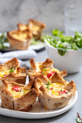 Egg muffins with peppers in a toast cup for breakfast brunch.