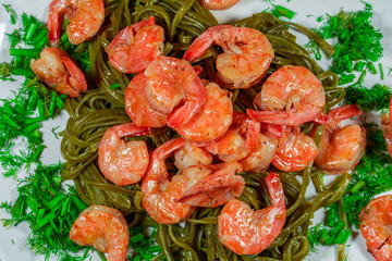 Shrimps with pasta and herbs. Home cooking.