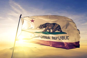 Fotobehang California state of United States flag waving on the top sunrise mist fog © Oleksii