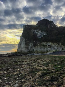 gray and brown cliff under gray sky