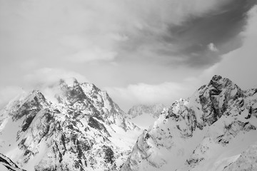 High mountain peaks covered with snow and sky with clouds
