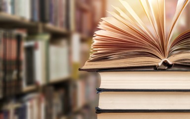Fototapeta premium Old stacked books on blurred background